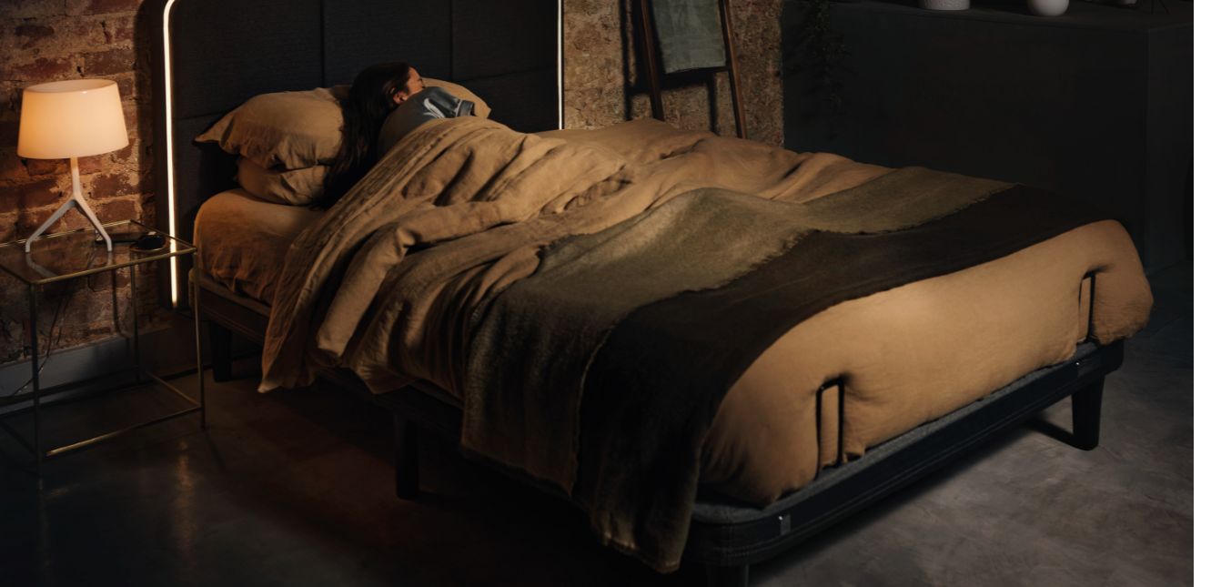 Women sleeping on an adjustable bed with a headboard